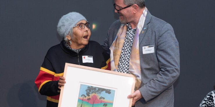 Alma Toomath (nee Cuttabutt) entrusting her own artwork from The Herbert Mayer Collection of Carrolup Artwork, c1946 into the care of Chris Malcolm, Director, John Curtin Gallery, at the Carrolup Centre for Truth-telling establishment ceremony, 10 November 2020, Curtin University.
